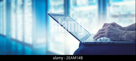 server support and management - it technician working on laptop in data center server room. copy space Stock Photo