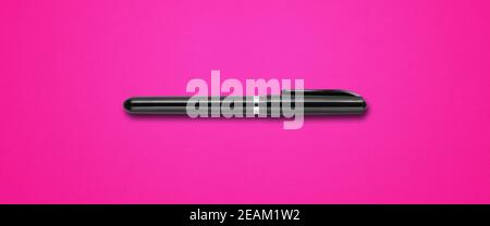 Black felt pen isolated on pink banner Stock Photo