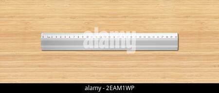 Metal ruler isolated on wooden background Stock Photo