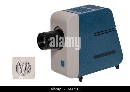 Vintage projector. Close-up of a old blue gray projector for viewing slides and filmstripes isolated on a white background. The projection lamp was adjusted with the aid of the pinhole diaphragm, which was used instead of a slide. Stock Photo