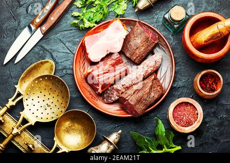 Chopping board of cured meat Stock Photo