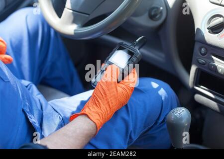 Auto mechanic using car diagnostic scan tool Stock Photo