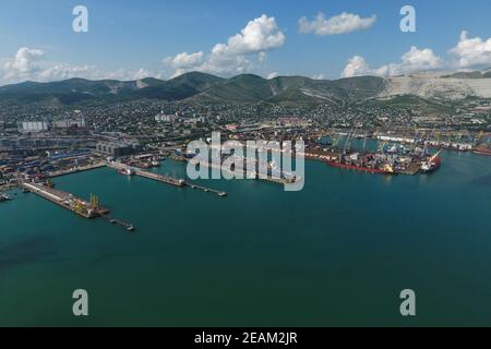 Industrial seaport, top view. Port cranes and cargo ships and barges. Stock Photo