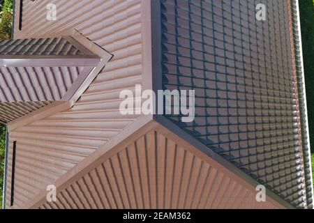 A view from above on the roof of the house. The roof of corrugated sheet. Roofing of metal profile wavy shape Stock Photo