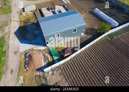 Buildings on the site. Hangar from metal profile, corrugated. Th Stock Photo