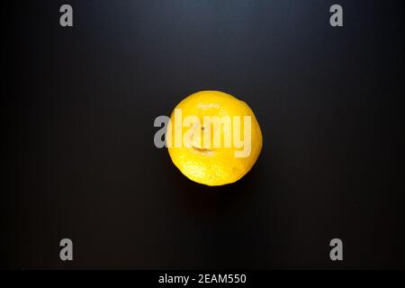 Yellow lemon on black table, food background Stock Photo