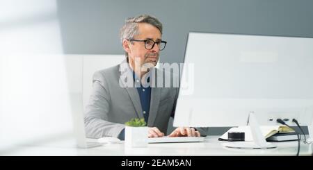 Happy Professional Man Employee Using Computer Stock Photo