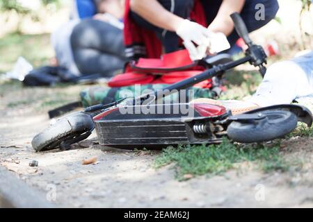 First aid for electric scooter rider injured in an accident Stock Photo