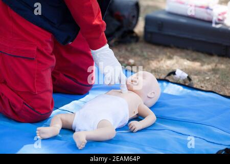 Baby CPR dummy first aid training. Heart massage. Stock Photo