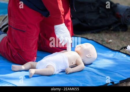 Baby CPR dummy first aid training. Heart massage. Stock Photo