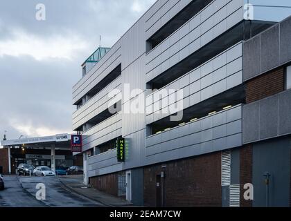 Sutton in Ashfield Multi storey modern steel carpark located in town centre market place at sunset with light reflecting on four levels Stock Photo