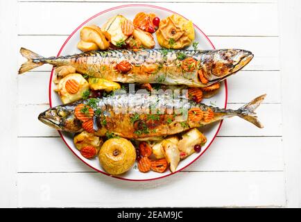 Tasty baked fish on plate Stock Photo