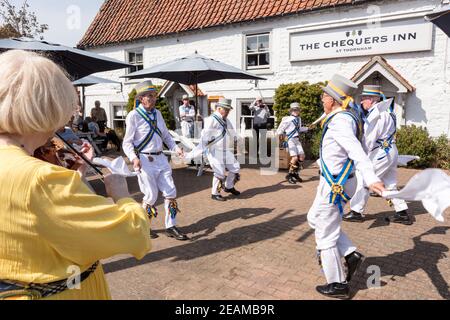 UK, Norfolk, Thornham, Chequers Inn, 2109, April, 22:. Morris Men, in white, gold and blue perform outside the Chequers Inn, Thornham, Norfolk,England Stock Photo