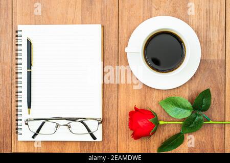 Valentines day concept ,Red roses on wooden table and notepad Stock Photo