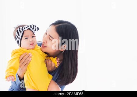 mother playing and smiling together with his newborn little baby Stock Photo