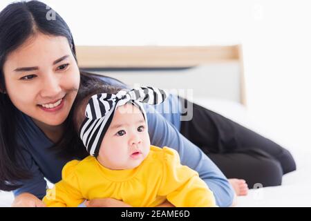 mother playing and smiling together with his newborn little baby Stock Photo