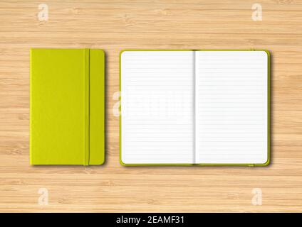 Lime green closed and open lined notebooks on wooden background Stock Photo