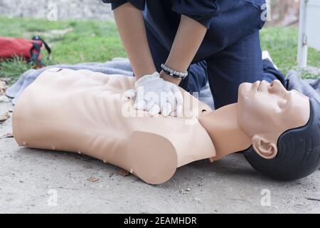 Paramedic demonstrates CPR on a dummy Stock Photo