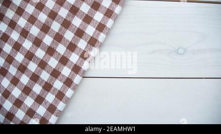 Wooden table covered with tablecloth cloth checkered Stock Photo