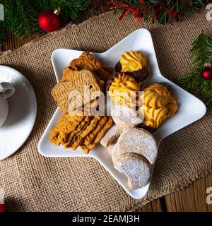 Different types of biscuits with rustic Christmas decorations Stock Photo