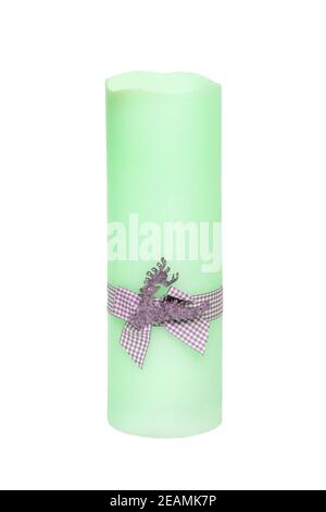 Christmas candle isolated. Closeup of a light green xmas candle with a light gray ribbon bow isolated on a white background. Beautiful xmas design element. Macro. Stock Photo