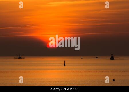 Silhouette of fishing trawlers on the North Sea at sunset, Buesum, Schleswig-Holstein, Germany Stock Photo