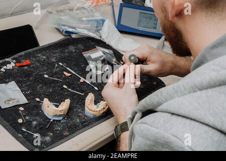 Dental Technician Working On A 3D Printed Mold For Tooth Implants In The Lab Stock Photo