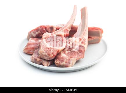 Slices raw lamb chops on plate Stock Photo