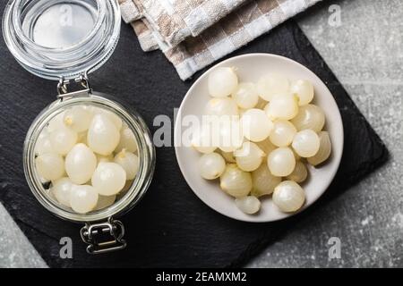 Pickled mini baby onions in jar Stock Photo