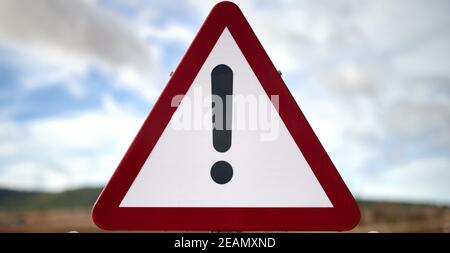 detail of a triangular traffic sign with the exclamation mark indicating some type of danger Stock Photo