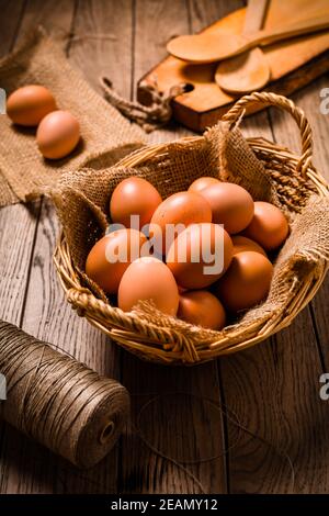 Organic eggs on wooden background, ready for baking Stock Photo