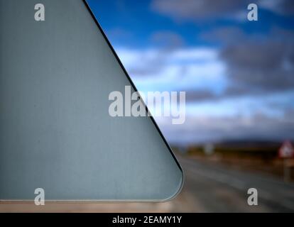 detail of a triangular traffic sign seen from the rear on a road on a blue sky and snowy day Stock Photo