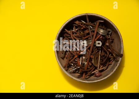 metal rusty nails on a yellow background Stock Photo