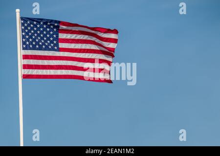 American flag against blue sky copy space Stock Photo