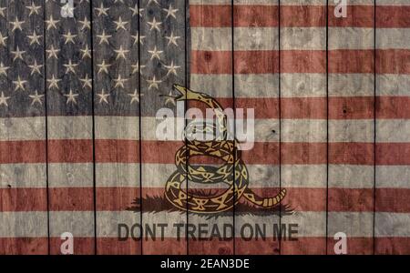 vintage faded American flag and don't tread on me banner painted on the side of a weathered wooden barn Stock Photo