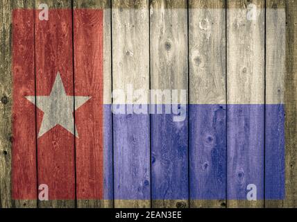 Faded Texas state flag painted on a weathered wood barn wall Stock Photo