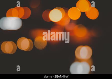 Blurred abstract background of city street lights bokeh illuminated at night. Stock Photo