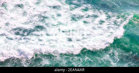 scenic aerial shot of blue ocean with foamy waves for background Stock Photo