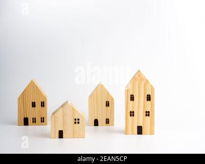 Wooden Miniature houses on white background. Stock Photo