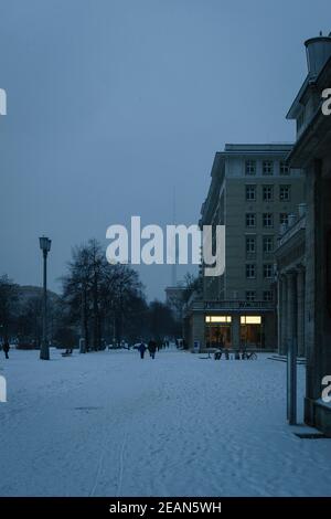 BERLIN, GERMANY - Feb 08, 2021: Snowy Karl-Marx-Alle with television tower in background Stock Photo