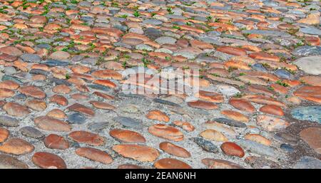 Cobbled, ancient city of stone road. Stone road texture Stock Photo