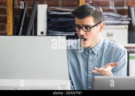 Workplace Quarrel. Angry Looking Man Stock Photo
