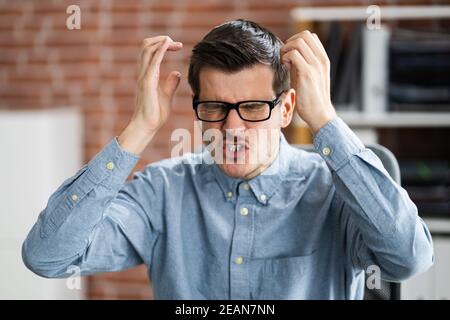Workplace Quarrel. Angry Looking Man Stock Photo