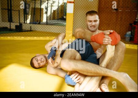 MMA fighter performs leg grab to his opponent Stock Photo