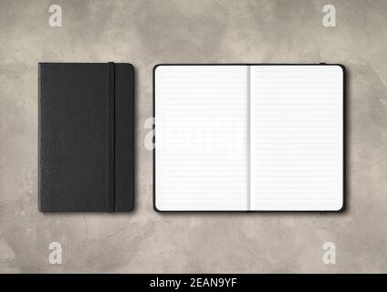 Black closed and open lined notebooks on concrete background Stock Photo