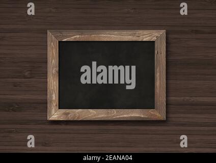 Old rustic black board isolated on a dark wooden background Stock Photo