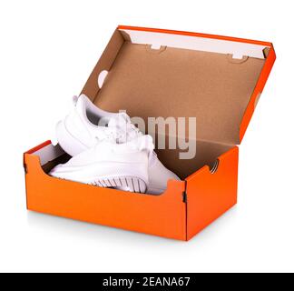 New white sneakers shoes in red box. Stock Photo