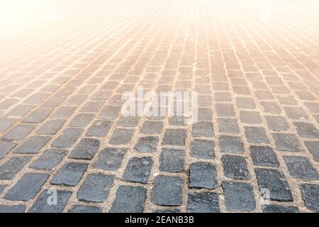 Granite cobblestoned pavement background. Selective focus Stock Photo