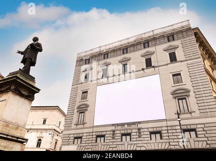 Blank advertising billboard on the scaffolding of the facade of an ancient building under restoration Stock Photo