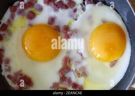eggs sunny side up in a pan Stock Photo